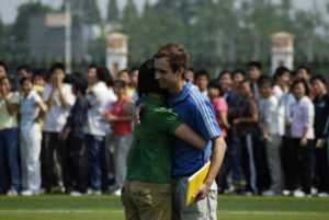 Rich giving a speech to 8000 students in a school near Wuhan