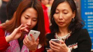 Chinese shoppers on mobile phones