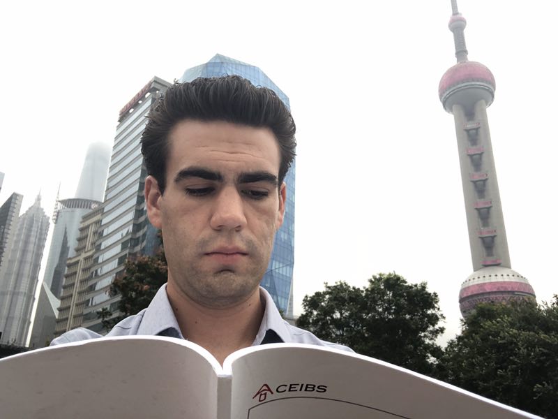 A CEIBS Student reading the school handbook